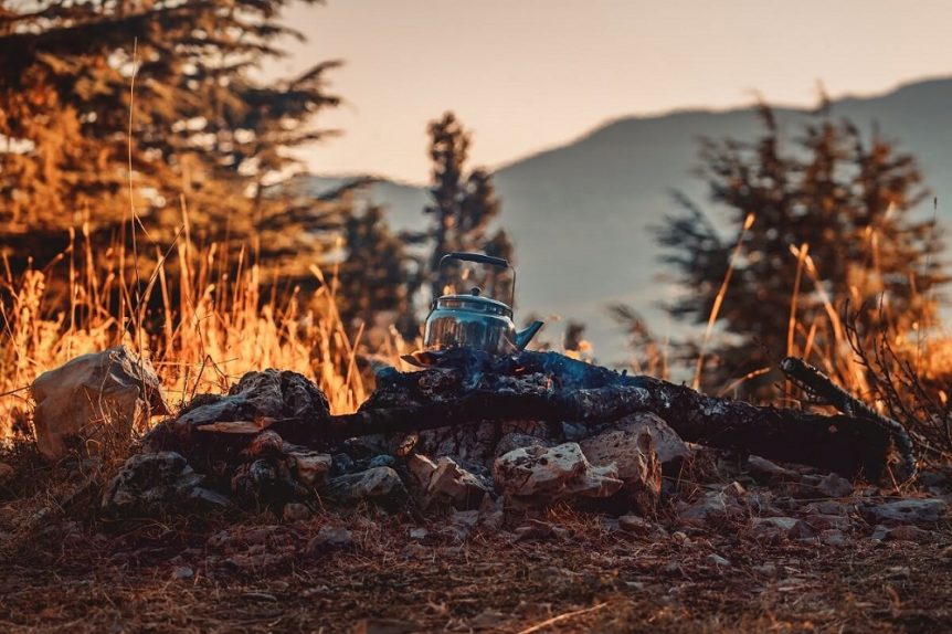 Teapot resting over campfire